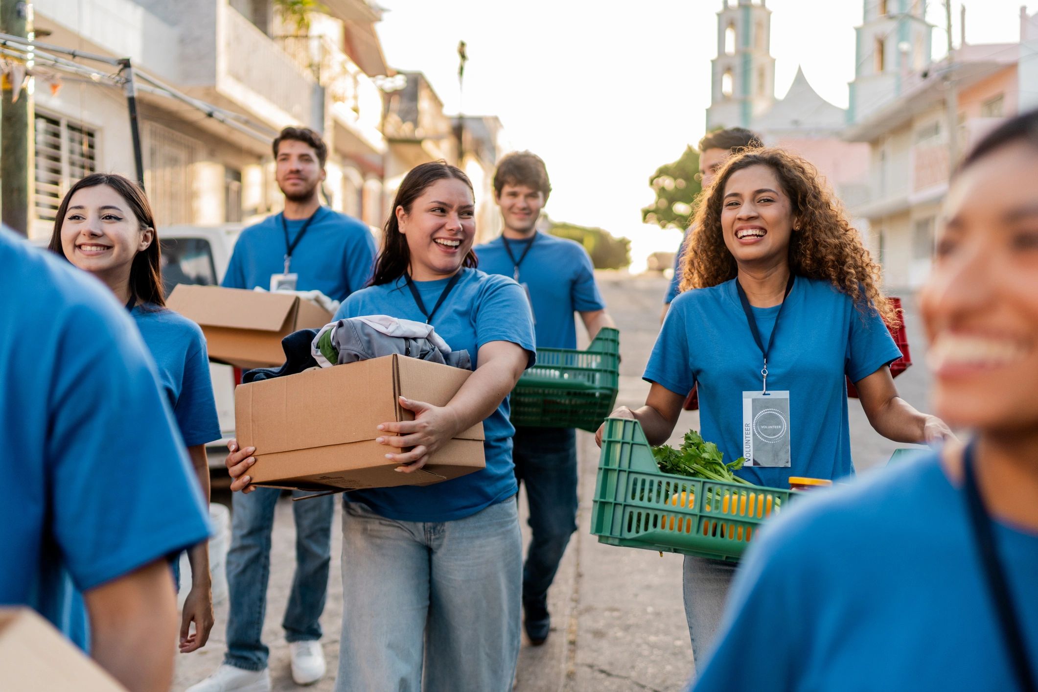 Volunteers carrying donation boxes outdoors